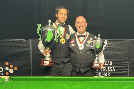 Carlos Correia and Henrique Correia pose with their trophies.