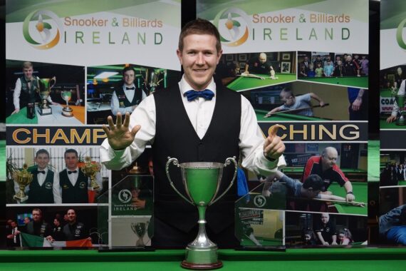 Brendan O'Donoghue poses with the Irish trophy and references number six with his fingers.