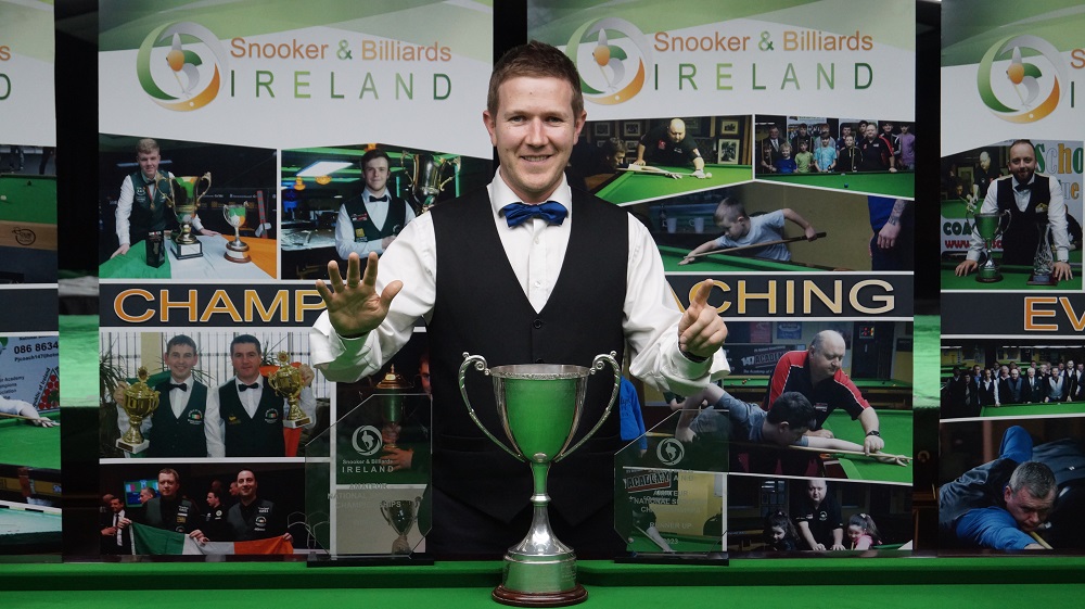 Brendan O'Donoghue poses with the Irish trophy and references number six with his fingers.