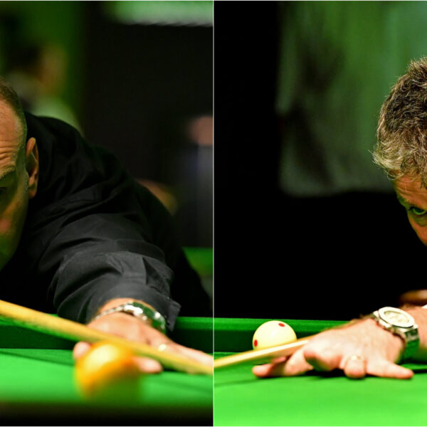 David Causier playing a shot on one side, Peter Gilchrist playing a shot on the other side.
