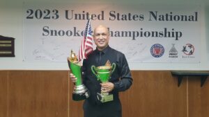 Daren Taylor holds both trophies with the USA flag sticking out of The Tom Kollins Trophy.