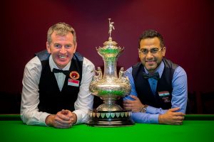 Peter Gilchrist and Sourav Kothari pose either side of The John Roberts Trophy.
