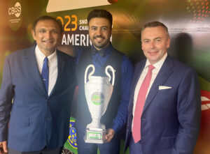 Jonas Luz holds his trophy and stands in between Ajeya Prabhakar and Jason Ferguson.