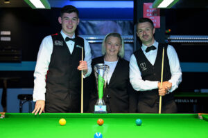 Davies and Holt pose with trophy before the final at the table and referee Satu Isolehto