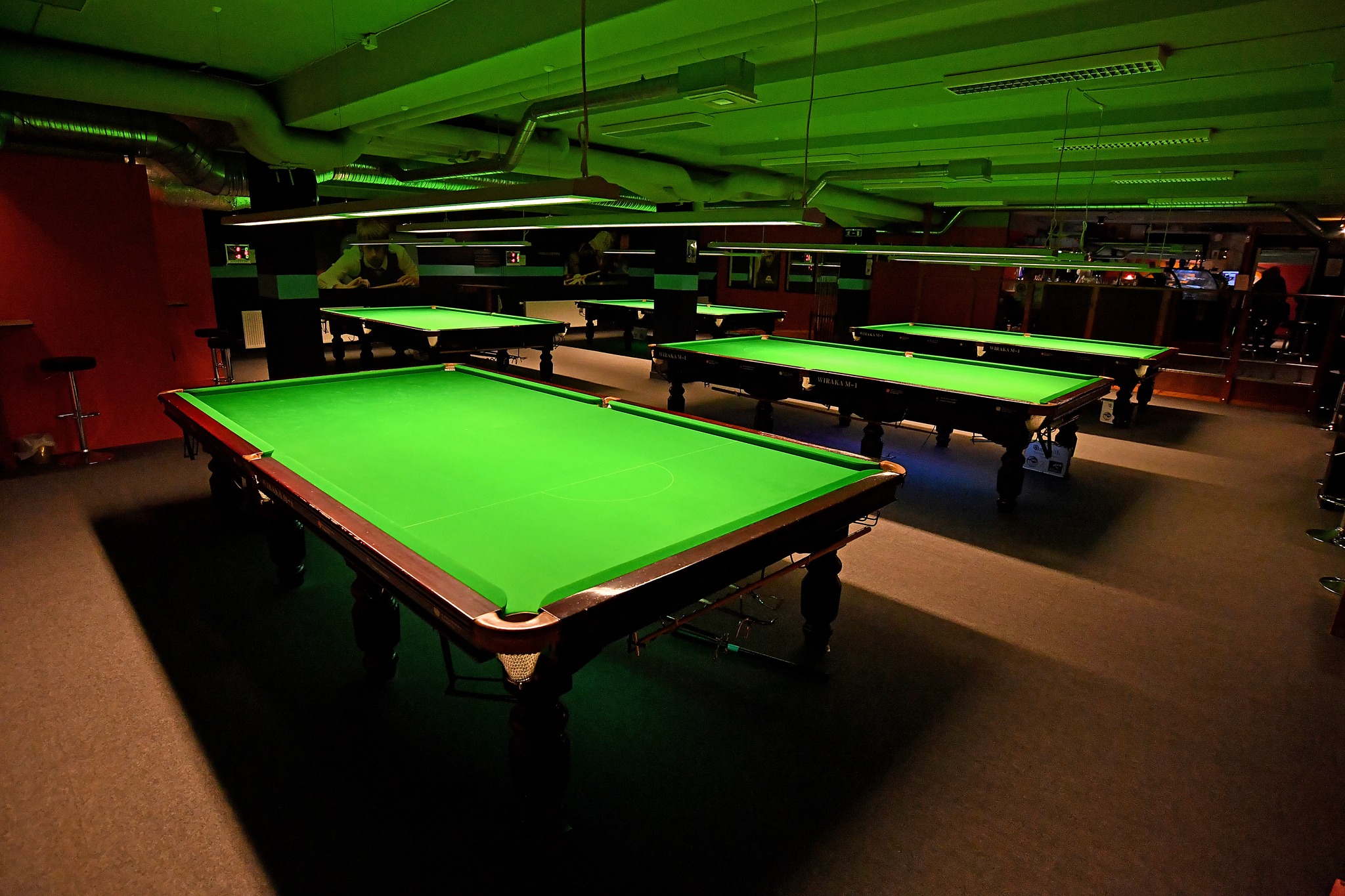 Inside the Snookerhallen venue with an image of several tables without the balls set up.