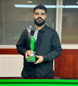 Umut Dikme poses for a photo holding the trophy.