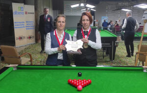 Wendy Jans and Anja Vandenbussche hold the trophy.